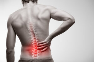 Man with glowing red lumbar spine illustration