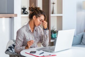 Woman suffering from tension headache and fatigue at desk