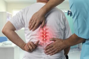 Patient with back pain receiving medical examination for radiculopathy treatment at MVM Health