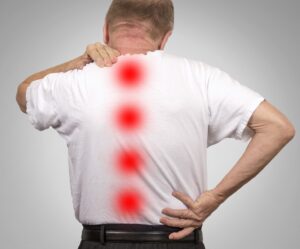 Patient with lower and upper back pain highlighting spinal stenosis symptoms