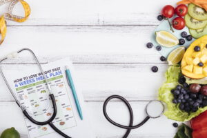 Healthy weight loss concept image with tirzepatide meal plan, fresh fruits, and medical stethoscope for MVM Health