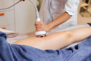 Shockwave therapy treatment on patient leg for pain relief and healing”