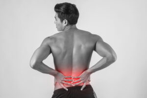 A man is holding his bank because of Spine Pain 