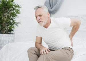 old man is holdig his back as he suffering from Hip Woes Unveiled