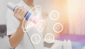 Medical professional using shockwave therapy device for pain treatment