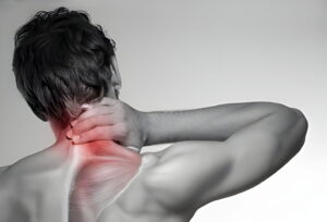 man is holding his neck as he is suffering from shoulder pain because of weak Neck Muscles