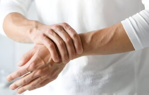 man is holding his hand as he is suffering from (PRP)