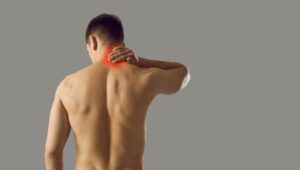 man is holding his neck suffering from pinched nerve
