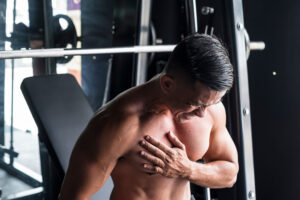 man at gym is suffering from Muscle Injurie and tears while doing workout