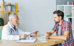 Doctor sitting at desk and check his patient
