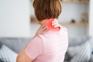 Woman experiencing neck pain and stiffness seeking neck pain treatment Stroudsburg