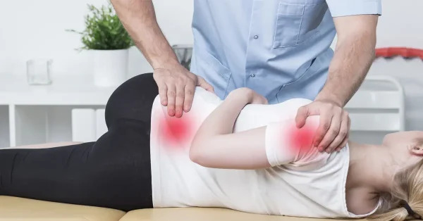 Chiropractor performing manual therapy for shoulder and lower back pain relief